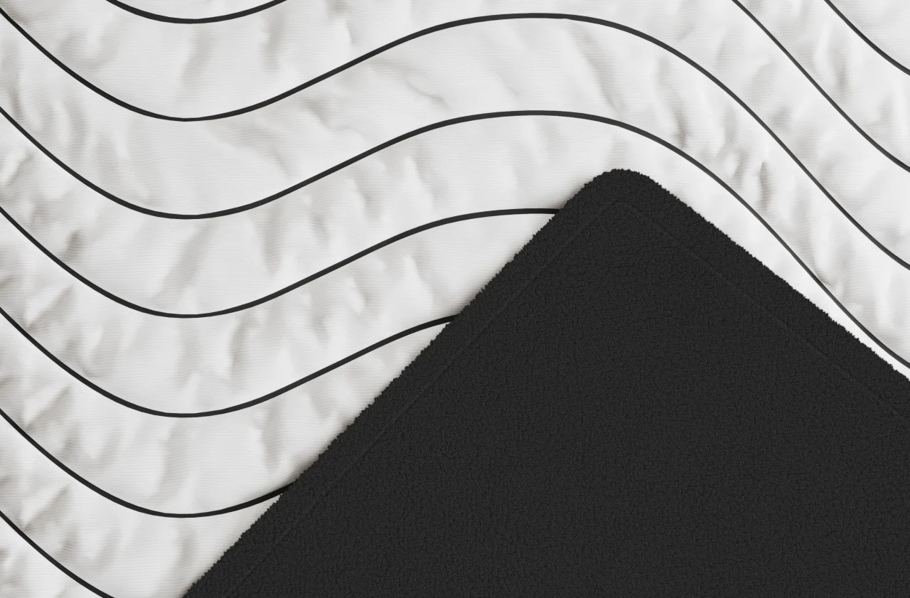 Close view of the Amerisleep Allseasons Blanket white Chill fabric and black fleece surfaces