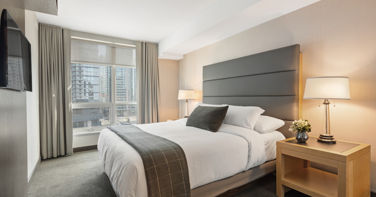 Tidy hotel bedroom with pillows arranged on the bed